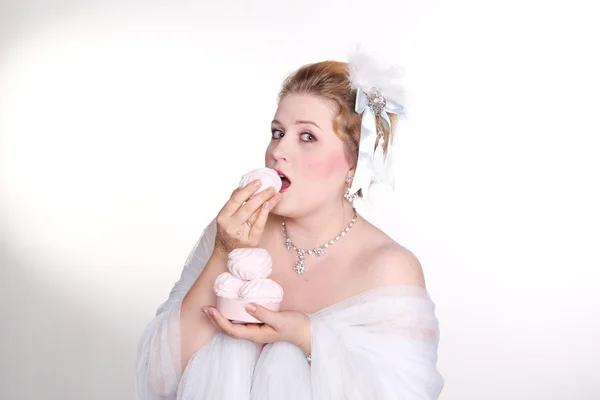 Plus size woman eats sweets with a pleasur — Stock Photo, Image